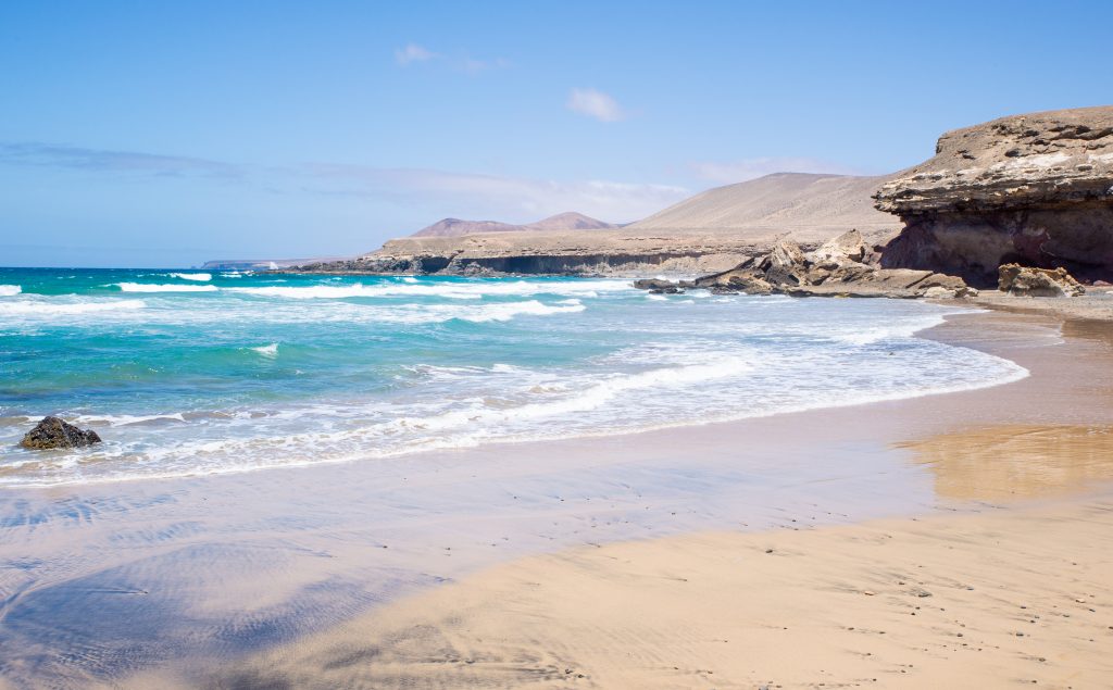 scenic view of beach and mountains on summer time, playa de garcey,fuerteventura,canary,spain.
